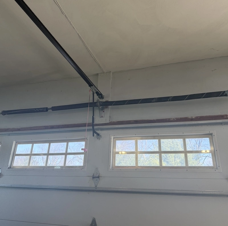 Broken garage door torsion spring with visible gap in coil, Carmel, IN