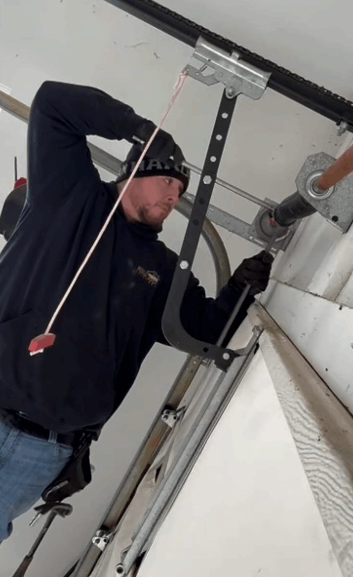 Tyler Rose doing an garage door spring repair on a Carmel, IN garage