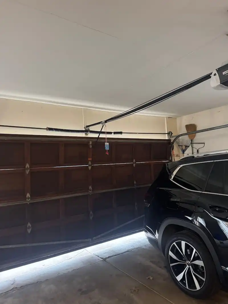 Broken garage door spring in Carmel, IN with car stuck inside garage