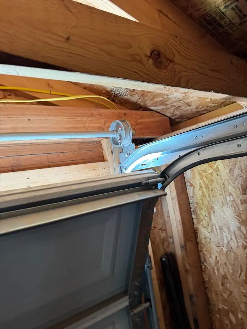  Garage door cable and drum assembly during repair in Carmel, IN